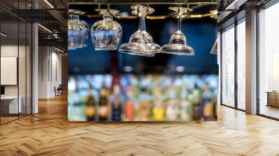 Glasses hanging over a bar rack in the hotel restaurant. Wall mural